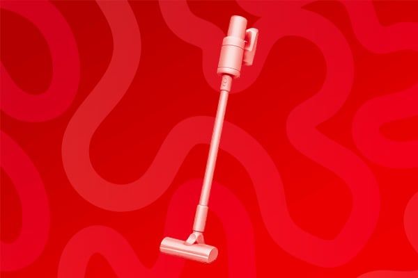 Un aspirateur balais sur un fond rouge