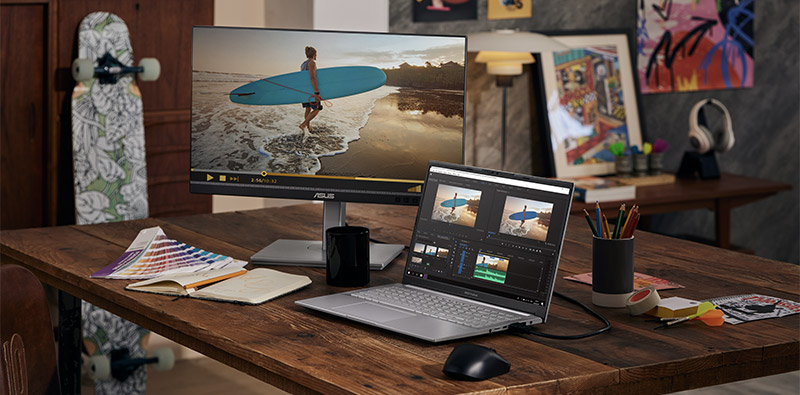 Een bureau met een Asus-scherm en een Asus Vivobook Pro 15 OLED-laptop 
